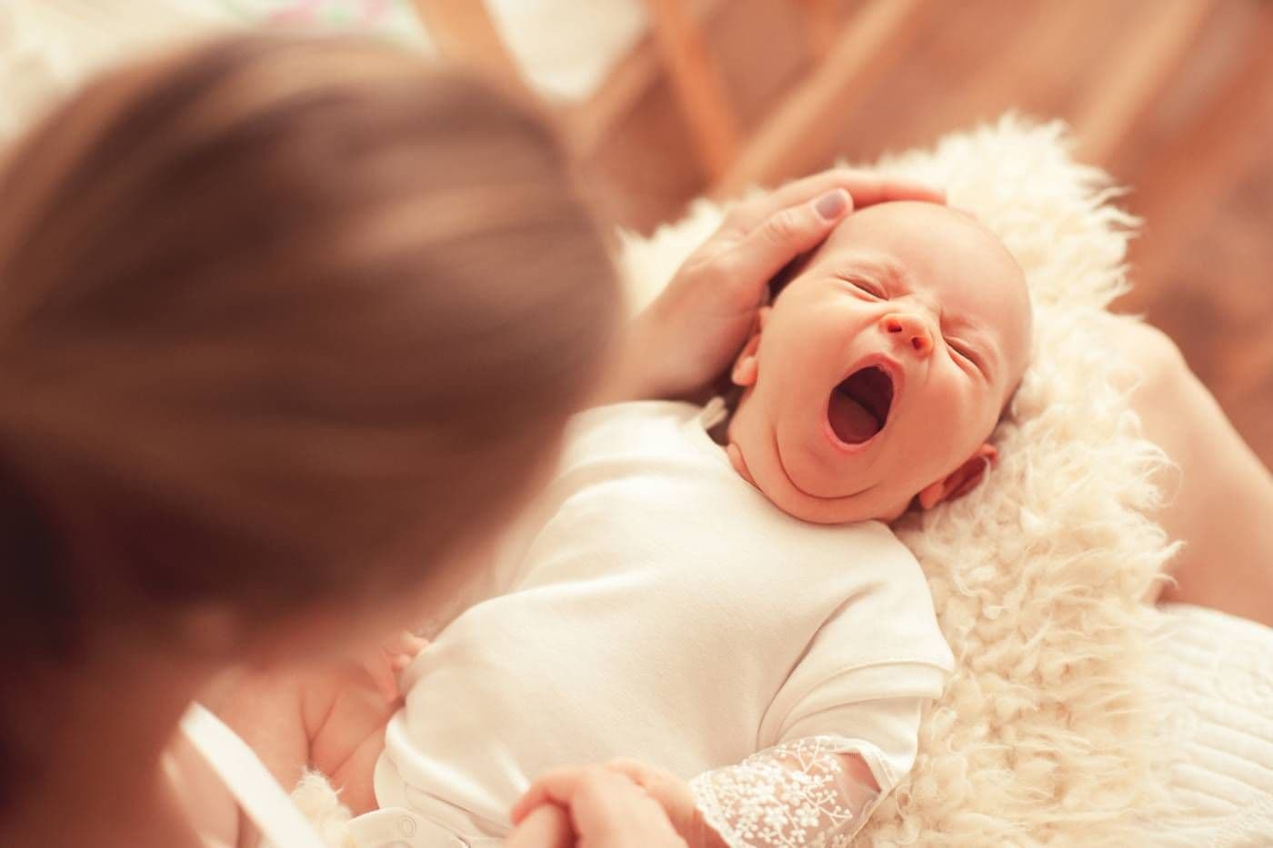 3-month sleep regression: mom holding a tired 3-month-old