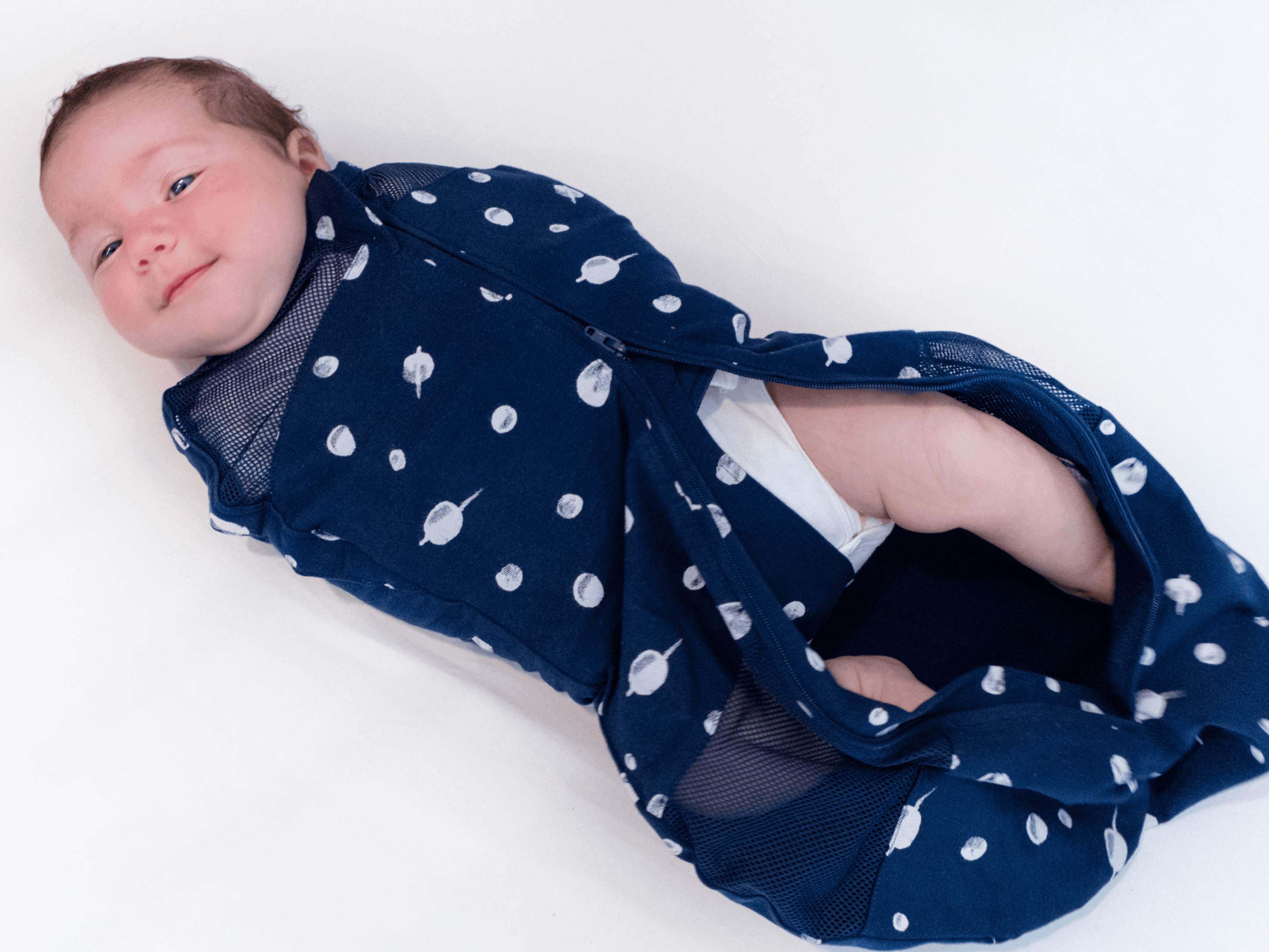 Baby in Sleepea with bottom zip undone for nappy change