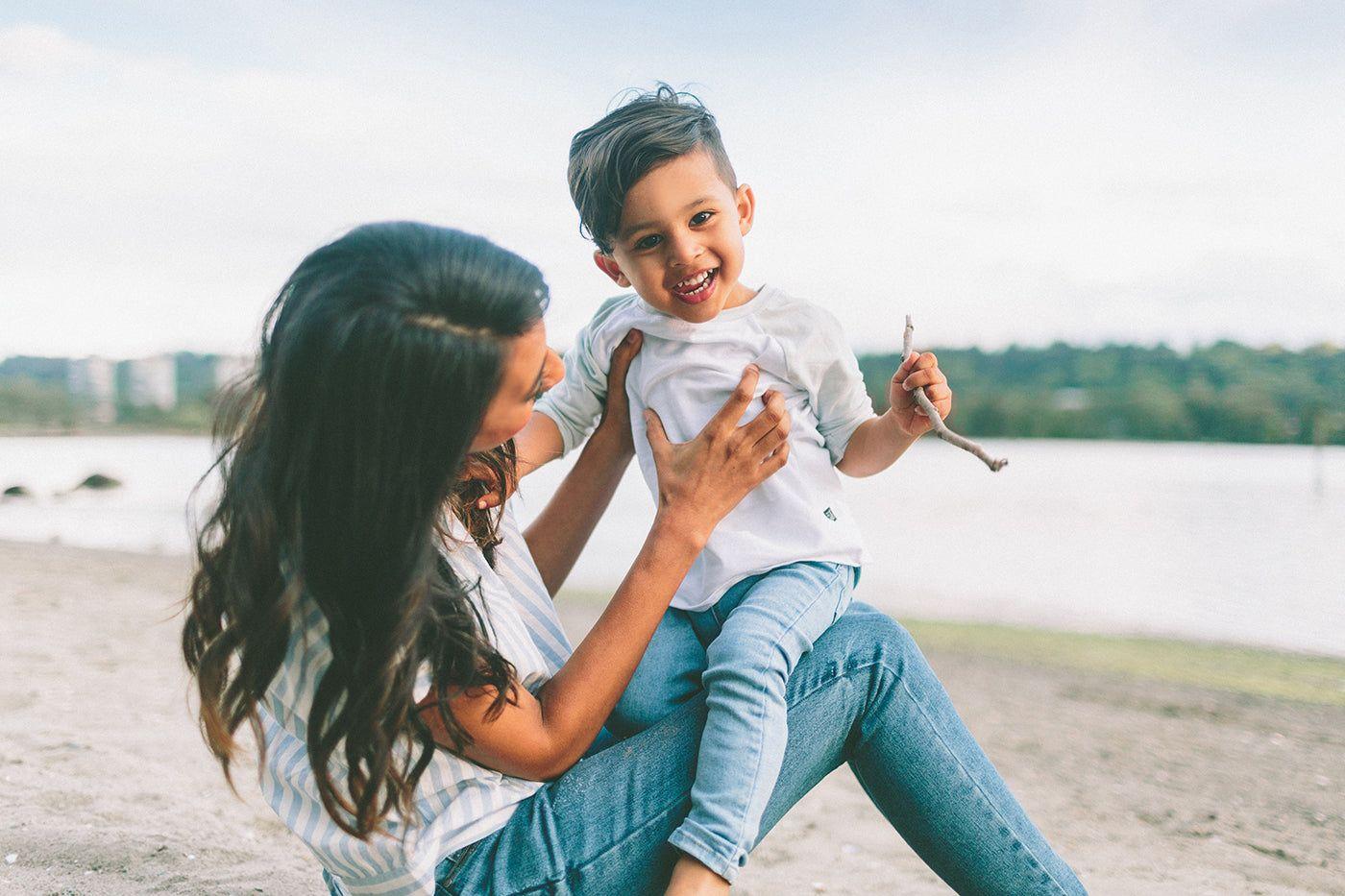 mom-playing-with-son-on-the-beach