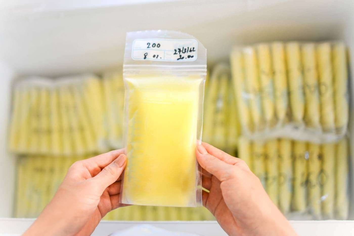 Mum storing breastmilk in a freezer