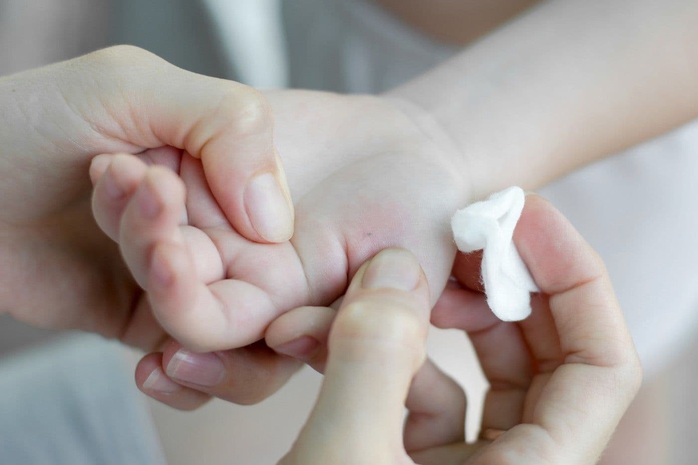 Removing a splinter from a toddler's hand