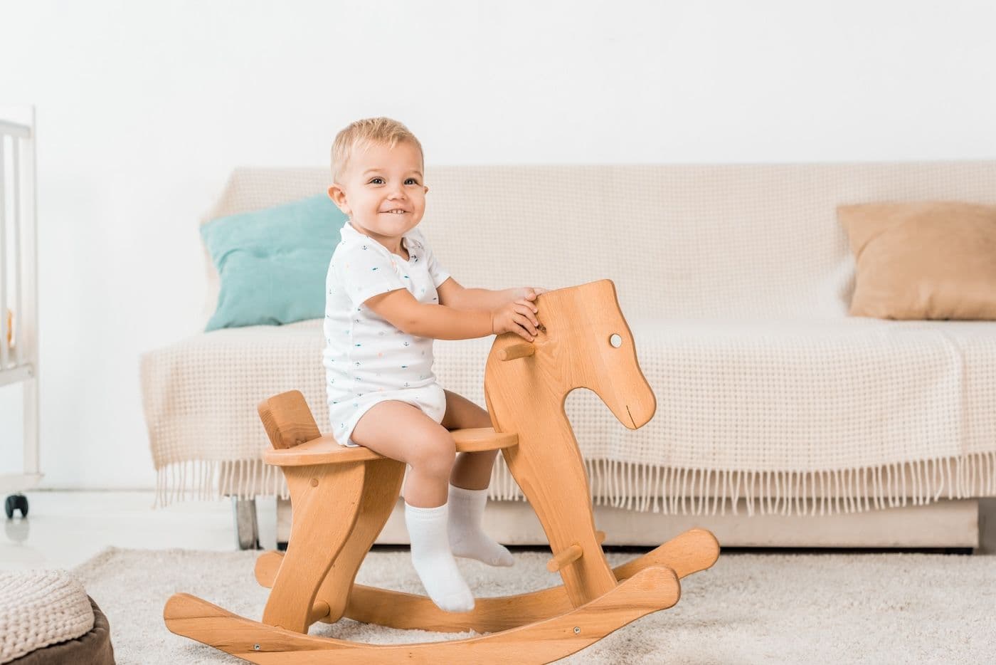 Baby on wooden rocking horse